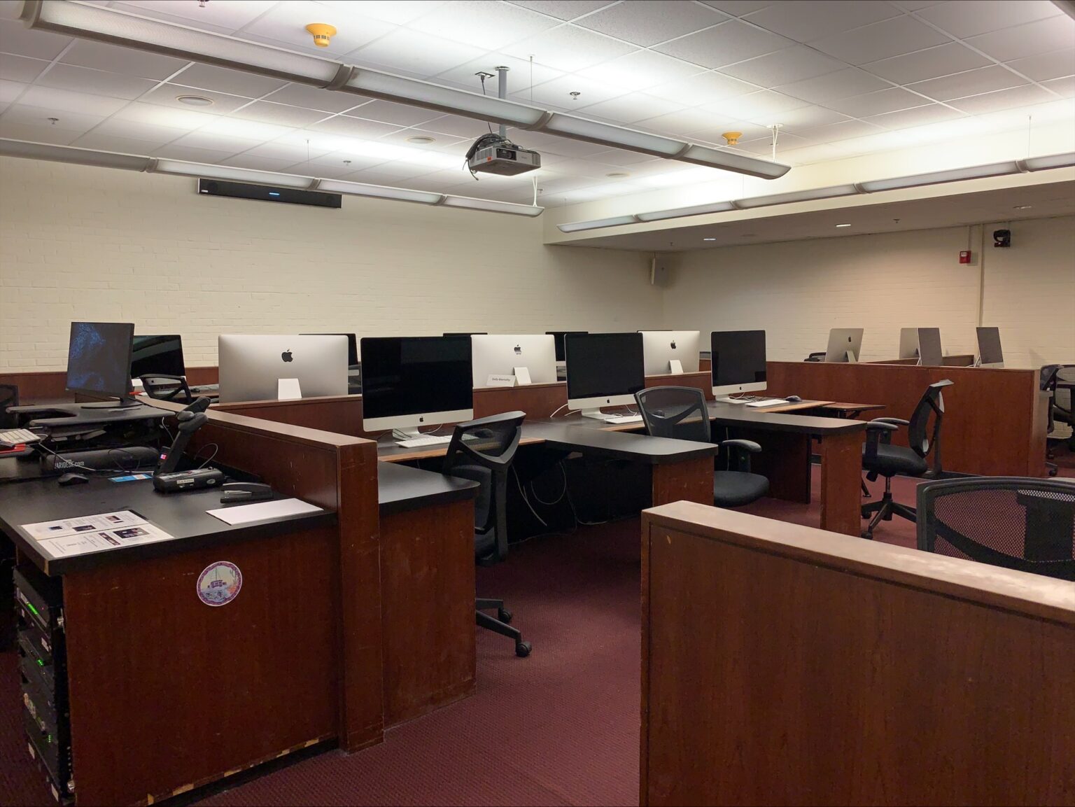 Alternate perspective of Carroll 060, with wooden desks and Mac monitors.