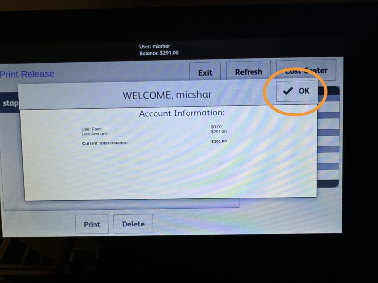 Printer welcome message, with the OK button in the upper right highlighted with an orange circle.